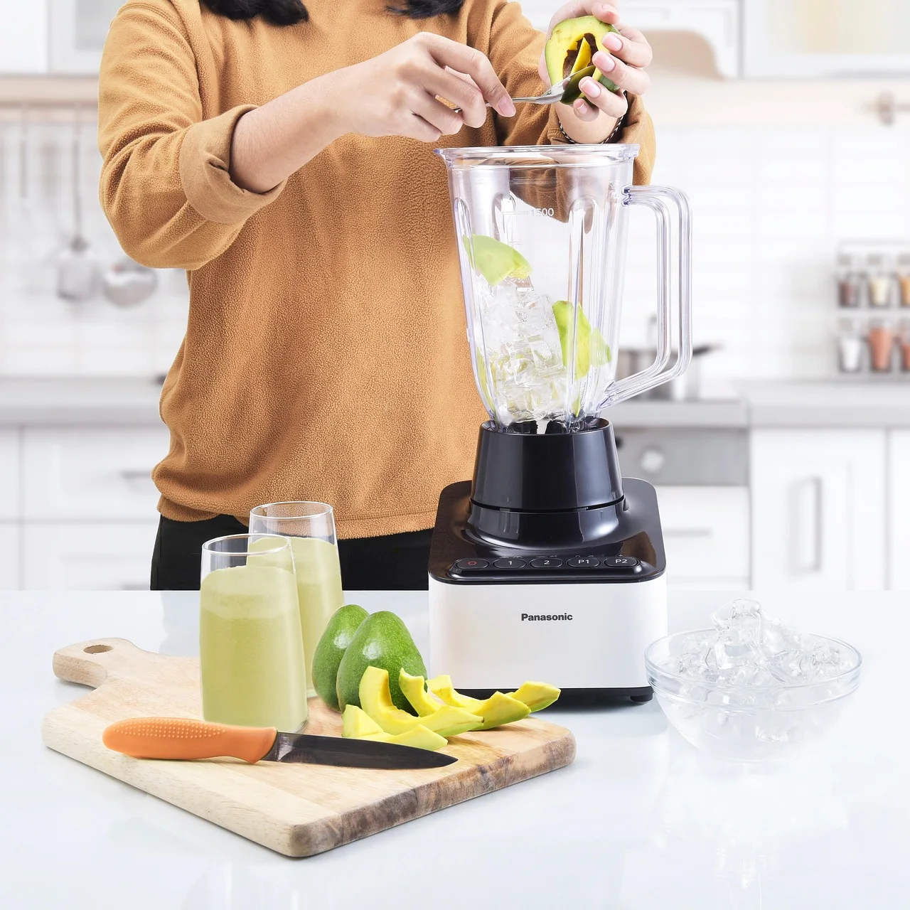 Electric countertop kitchen blender with clear measuring jug standing on a clean kitchen prep surface