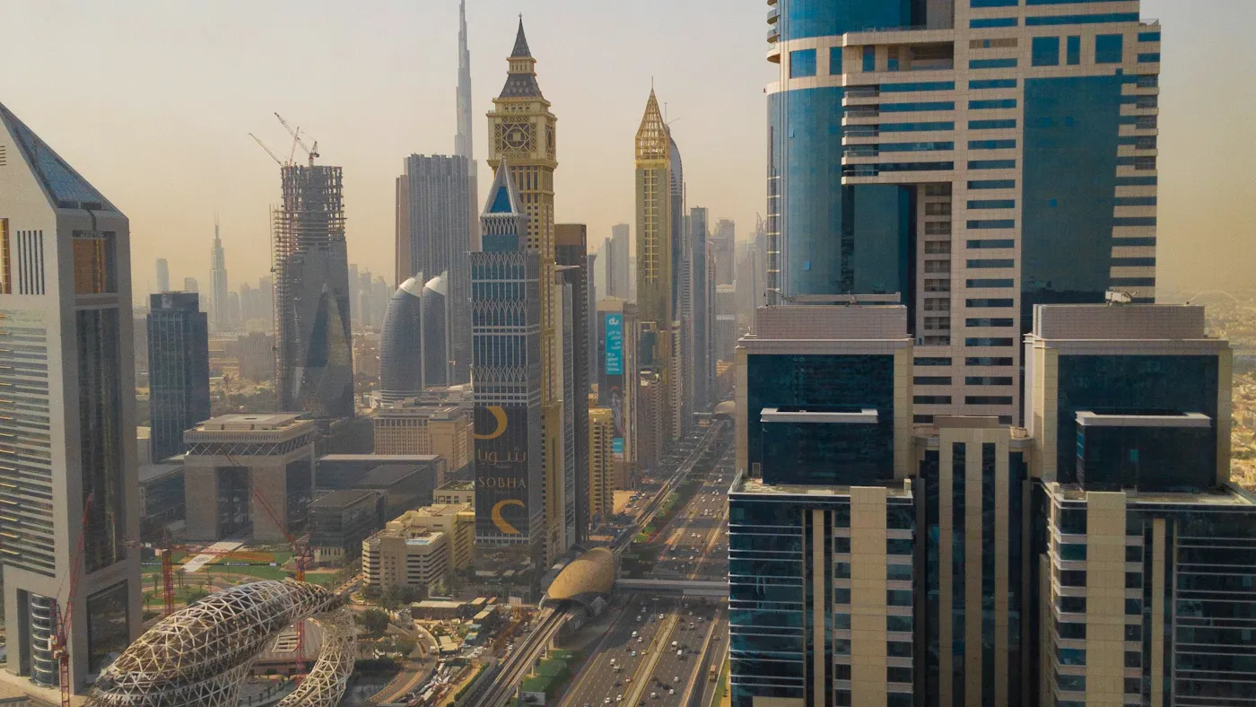 Aerial view of a blue and white high-rise residential tower in Dubai