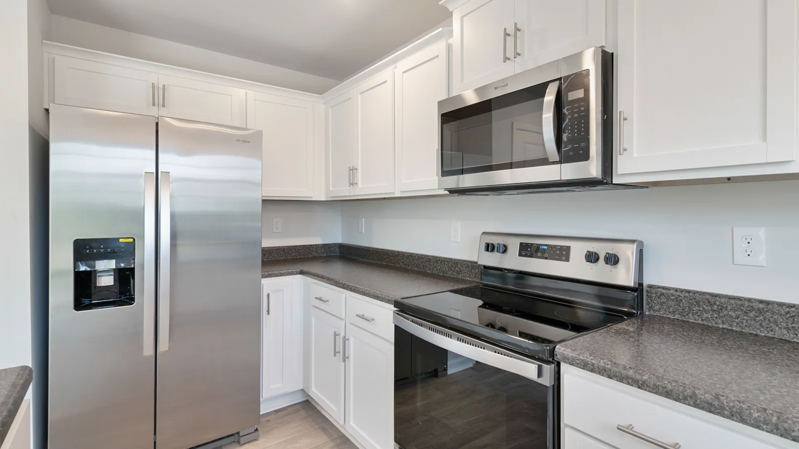 Modern kitchen fitted with stainless-steel household appliances — fridge, oven and microwave — the kind cleared during appliance removal in Dubai