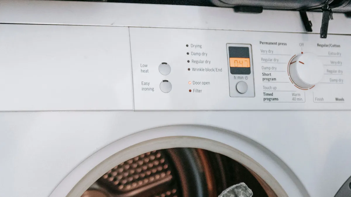 Front-loading washing machine with an open drum, the kind removed and recycled during washing machine removal in Dubai