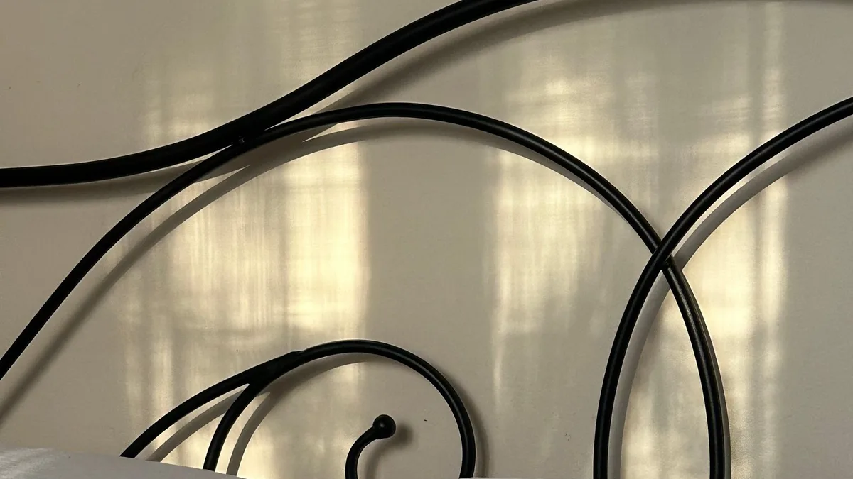 Ornate black metal bed frame and headboard being prepared for bed frame removal and collection in Dubai
