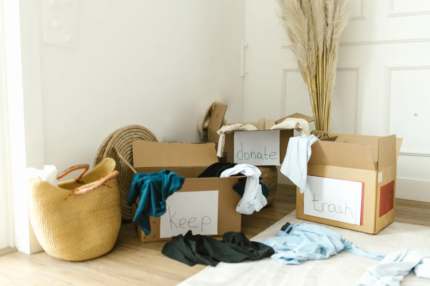 Cardboard boxes labelled Keep, Donate and Trash for sorting household items before an affordable junk removal collection
