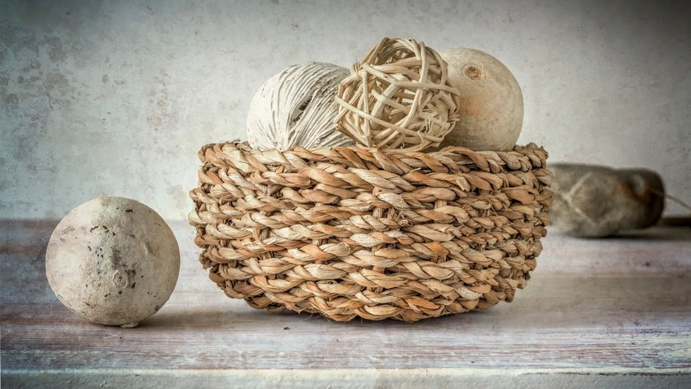Woven storage baskets and organized storage containers arranged neatly on apartment shelving