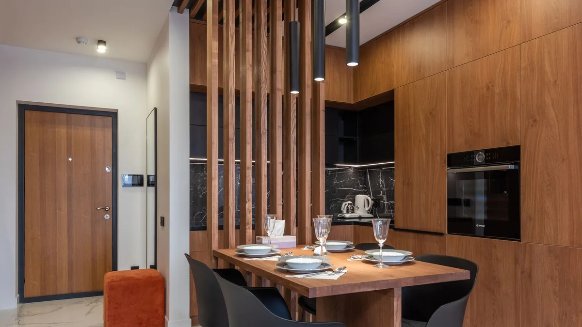 Compact modern dining table and chairs in a Dubai apartment with marble flooring, showing apartment dining set collection