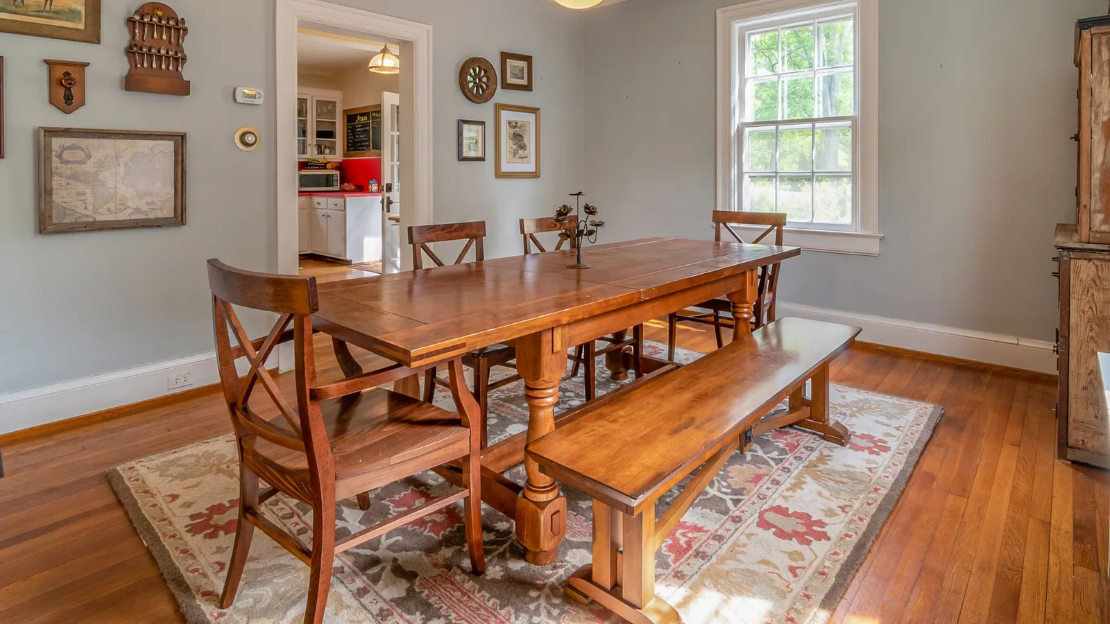Solid wooden dining table with matching chairs and a bench in a Dubai villa dining room being cleared for professional dining table removal