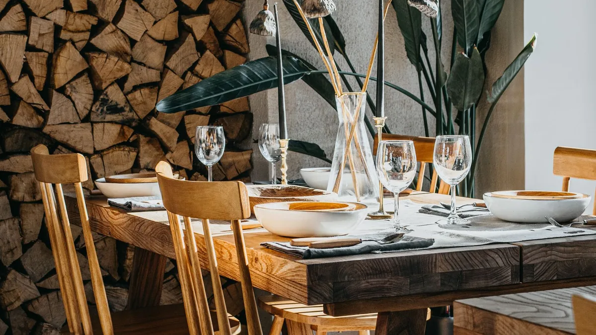 Solid wooden dining table with matching wooden chairs and glassware, representing wooden dining table and chair removal in Dubai