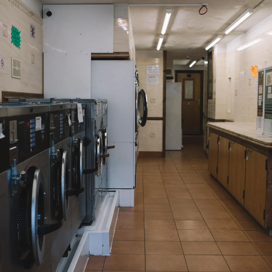 Home and building laundry machines lined up, showing apartment appliance collection and dryer pickup in Dubai