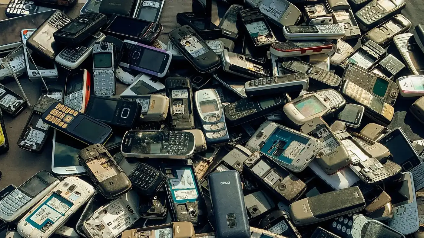 Pile of old mobile phones and devices representing electronics disposal and e-waste recycling in Dubai