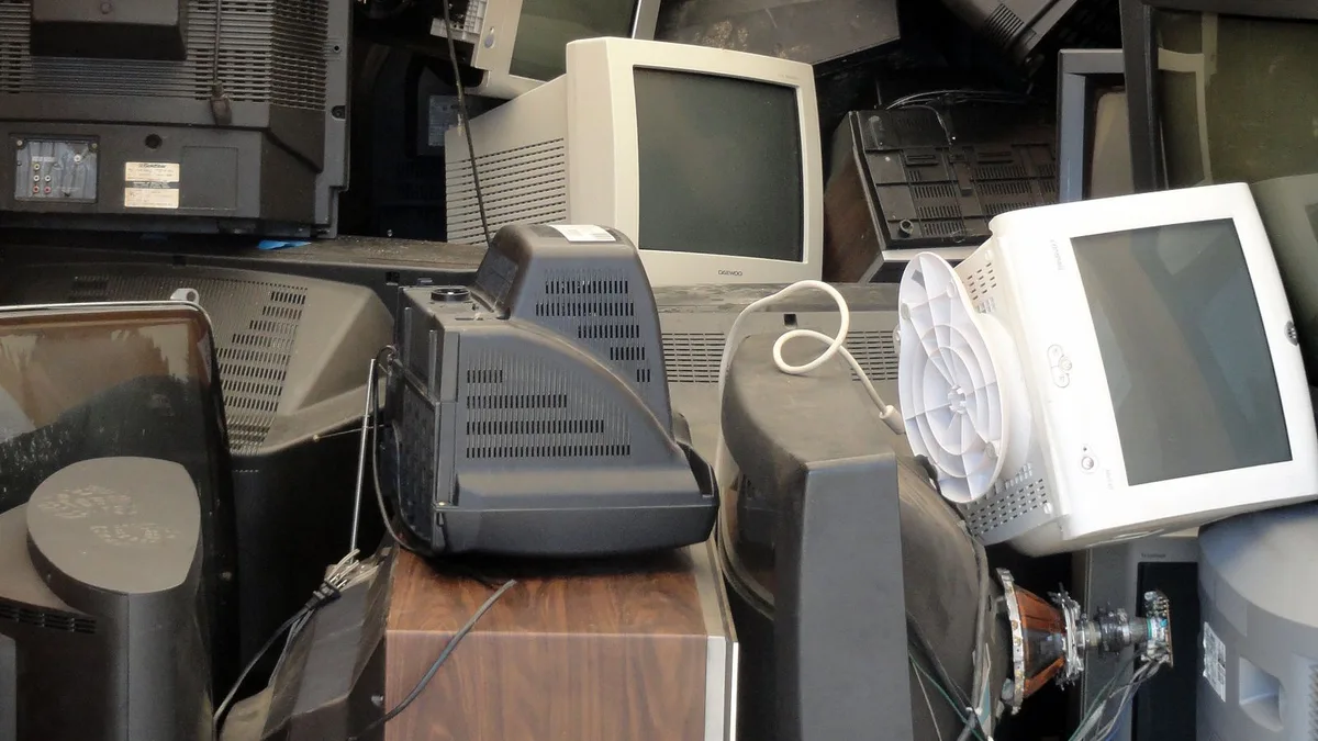 Stacked old televisions and monitors ready for TV disposal and electronic waste recycling in Dubai