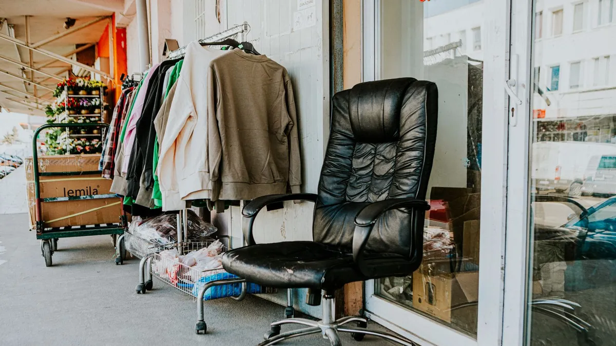 Used office chair and second-hand items outside a resale shop, illustrating donating and reselling as furniture disposal options in Dubai