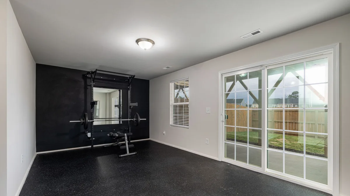 Home workout room filled with fitness equipment including a bench and resistance machines in Dubai