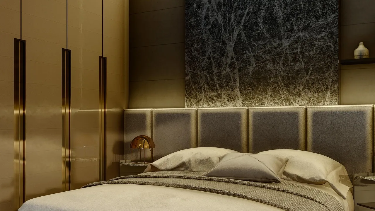 Refurbished hotel suite with a padded fabric headboard, marble-effect wall panel and neatly made bed