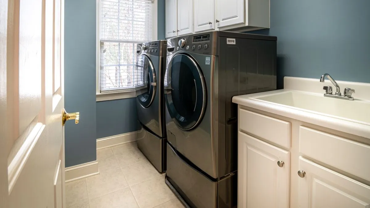 Home laundry room with a washing machine and dryer set for washing machine removal and pickup in Dubai