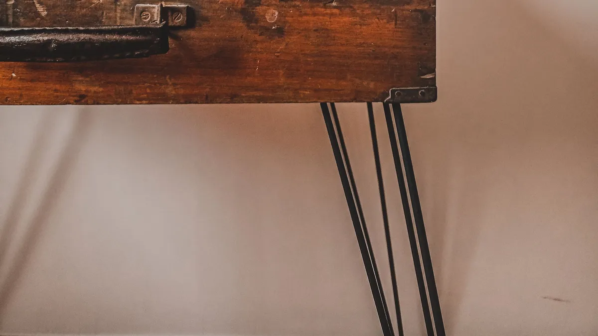 Old wooden chest upcycled into a table with new hairpin legs, an example of repurposing furniture in Dubai