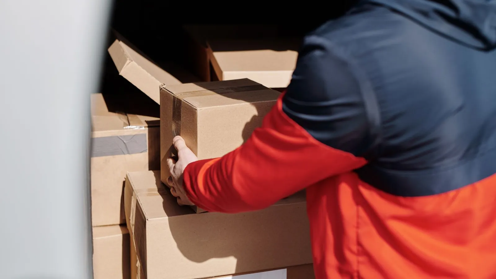 Uniformed junk collection crew member loading unwanted items into a van during a professional junk collection in Dubai