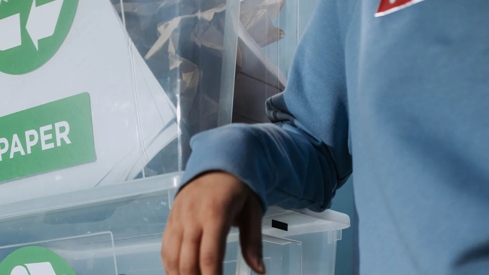 Worker sorting recyclable plastic containers at a waste sorting point in Dubai