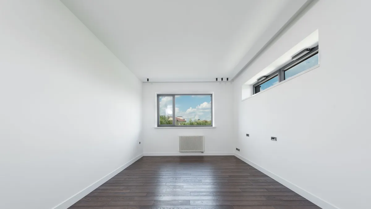 Empty, broom-clean room with wood flooring after a house and villa clearance in Dubai