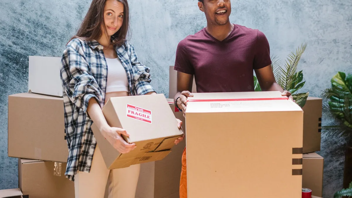 Uniformed crew carrying packed boxes and household items during a junk removal and clearance job in Dubai