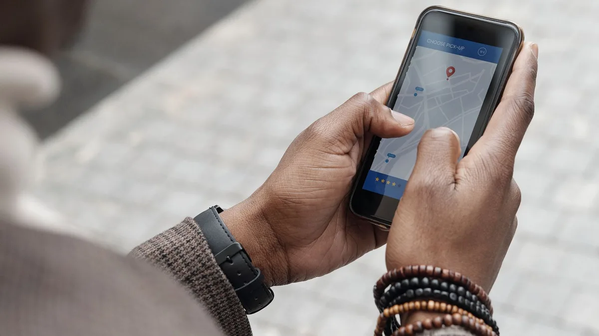 Person using a phone map with a location pin to find junk removal near me in Dubai