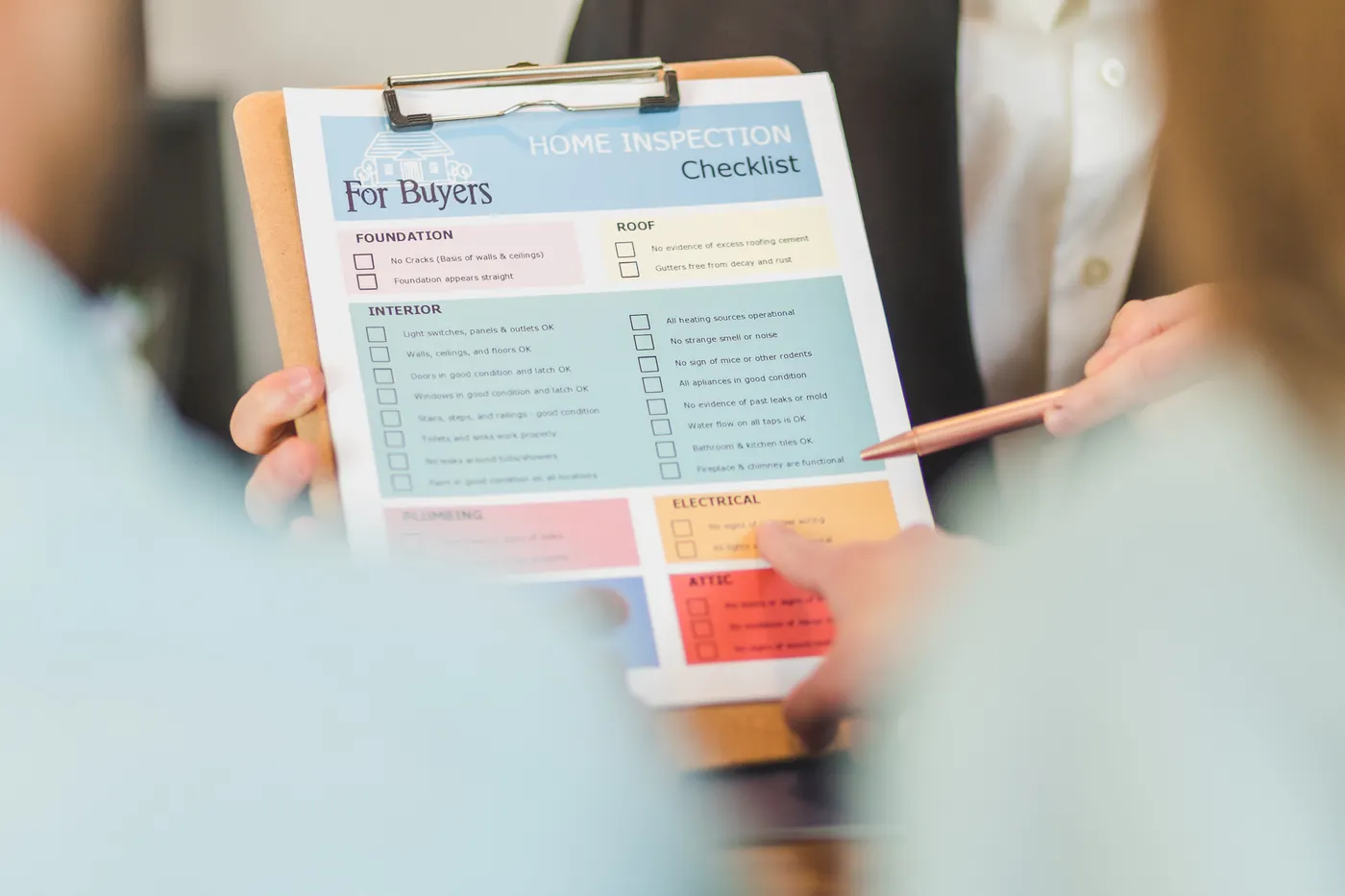 Close-up of hands holding a checklist clipboard, used for reviewing questions before accepting a junk removal quote in Dubai