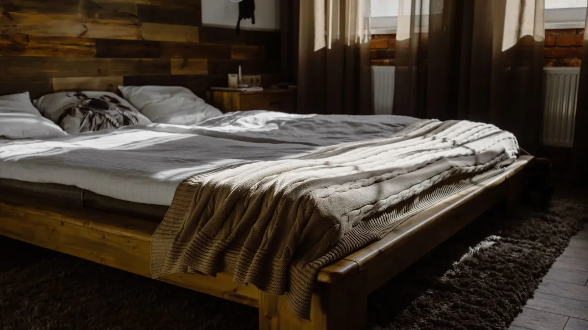 Solid wooden bed frame in a Dubai bedroom being cleared during bed base and frame removal
