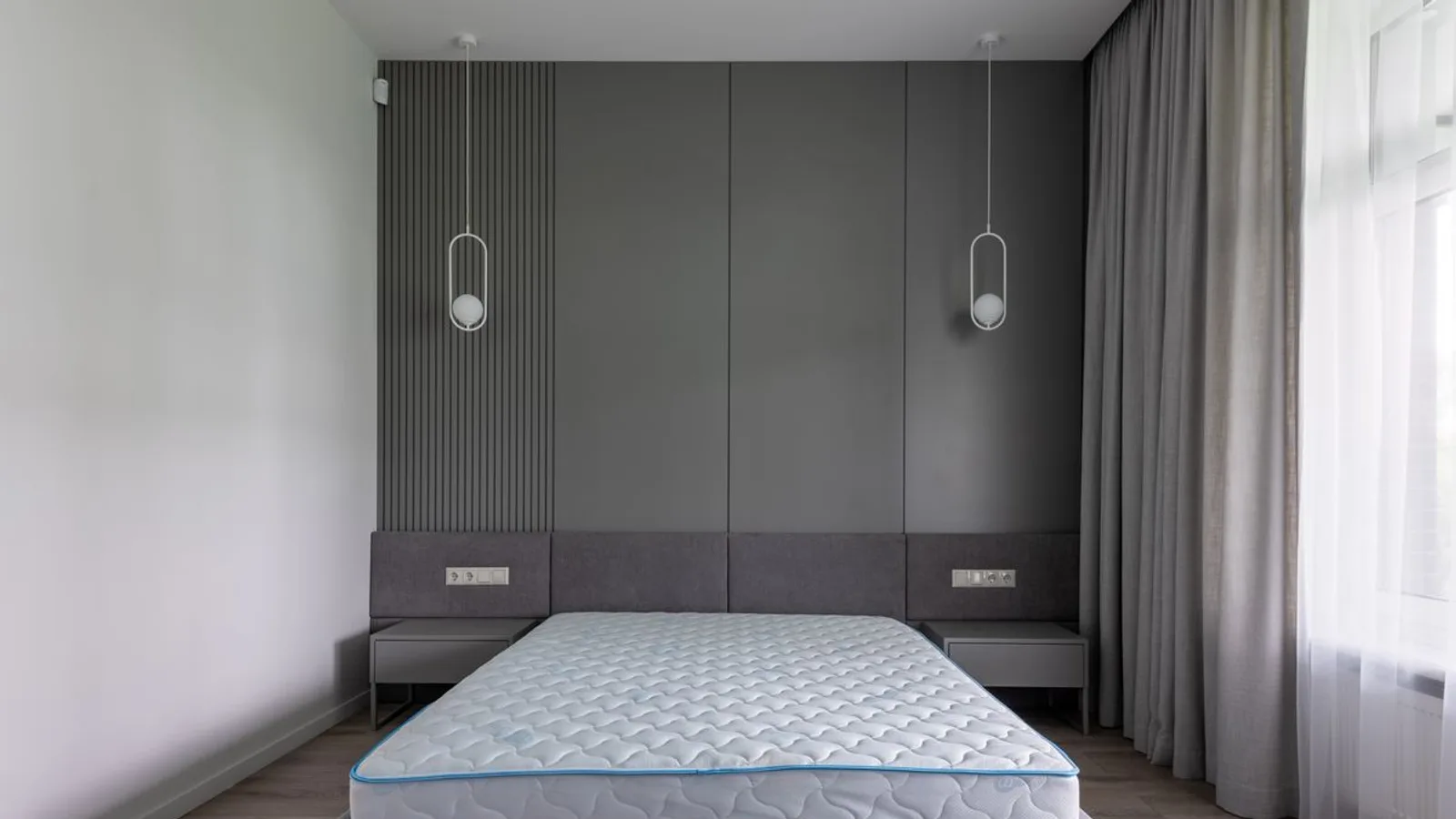Bare quilted mattress on a bed base in a modern Dubai bedroom ready for professional mattress pickup
