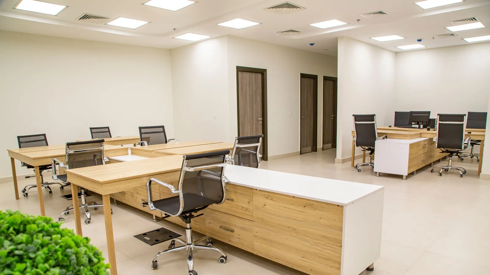 Row of modern office workstation desks and ergonomic chairs in a Dubai office cleared during professional office desk removal