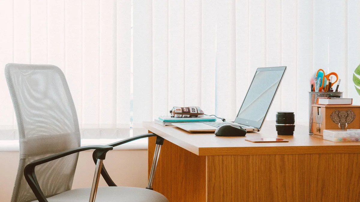 Single wooden home-office desk with chair and laptop in a Dubai apartment ready for office desk pickup