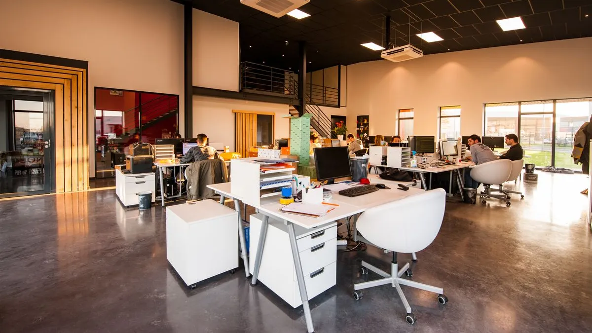 Open-plan Dubai office with desks, chairs and filing cabinets during office furniture removal