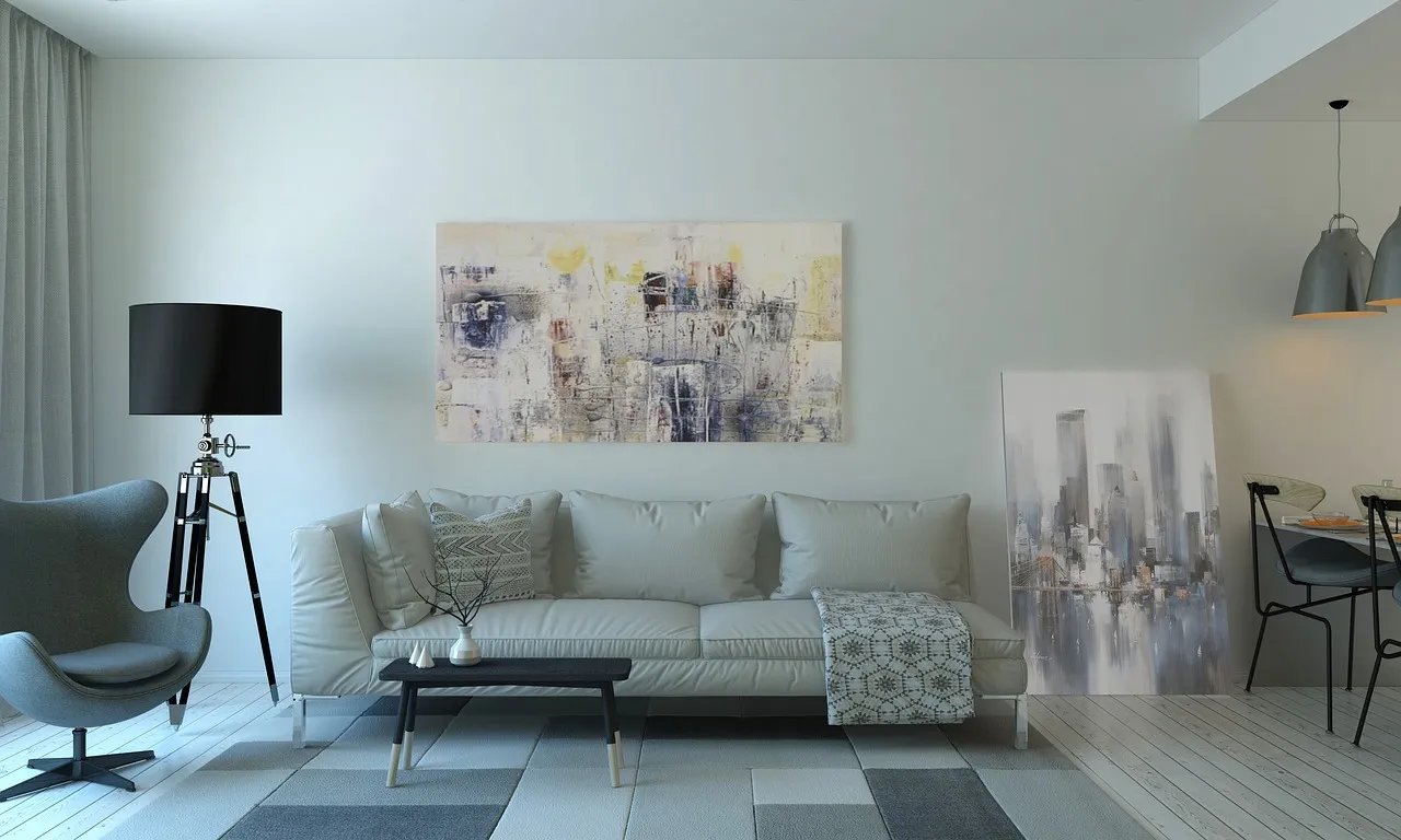 Minimalist living room with a grey sofa, coffee table and wall art kept in place for viewings