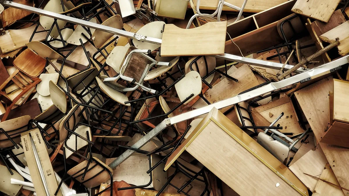 Pile of old furniture, chairs and bulky household waste gathered for rubbish collection and property cleanup in Dubai