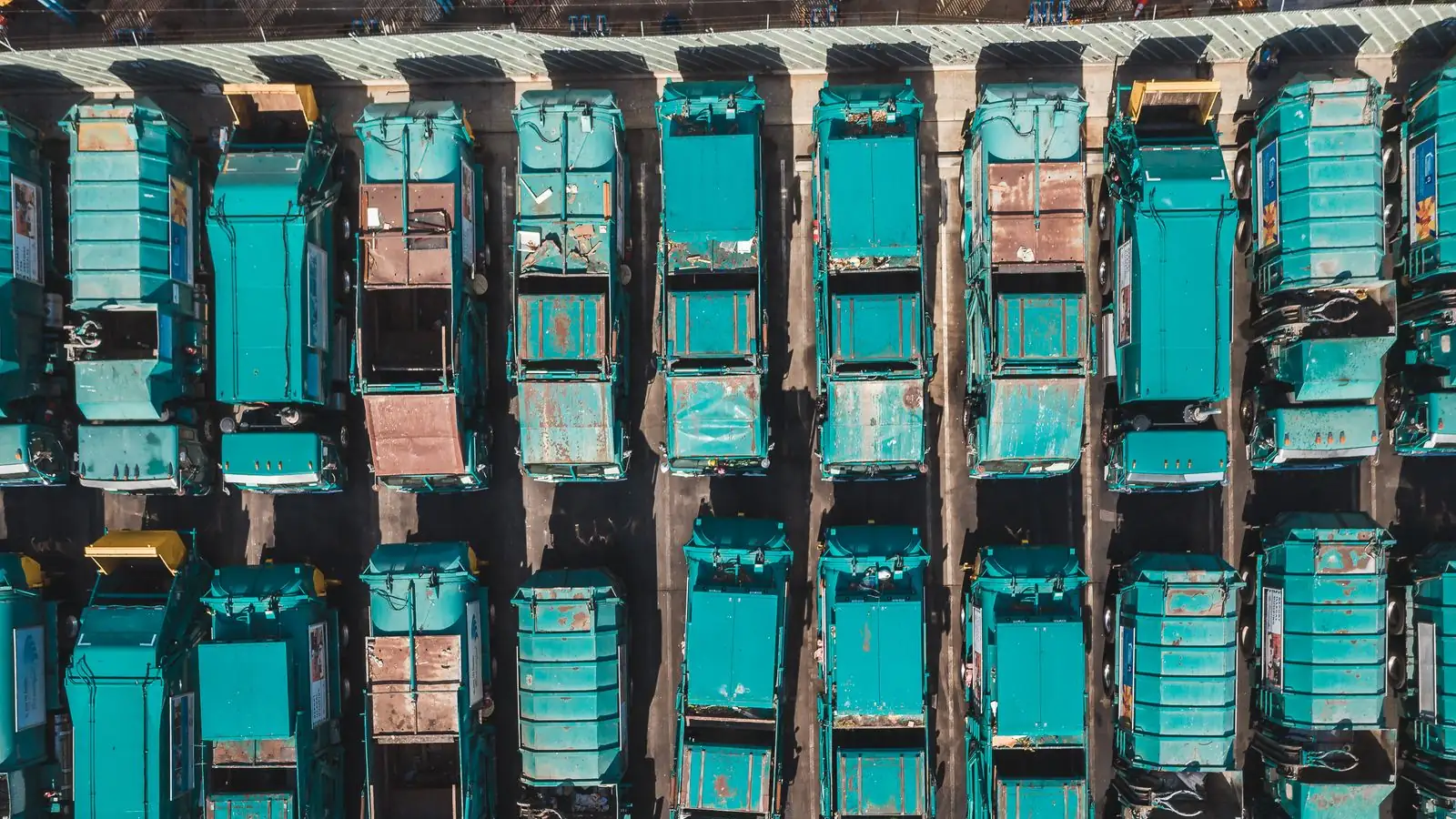 Fleet of rubbish collection trucks lined up ready for reliable household and commercial rubbish collection across Dubai