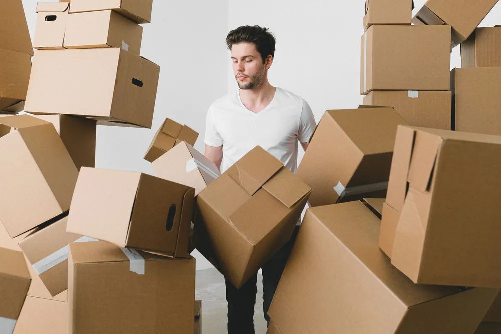 Large volume of household rubbish and boxes being lifted and cleared during a rubbish removal job in a Dubai home
