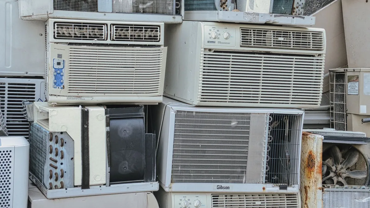 Stack of old air-conditioning and white-goods appliances set aside for same day junk removal and recycling in Dubai