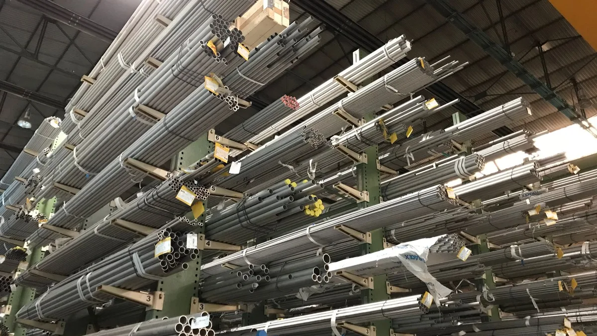 Racks of new steel tube stock in a warehouse, the end product of recycled scrap metal