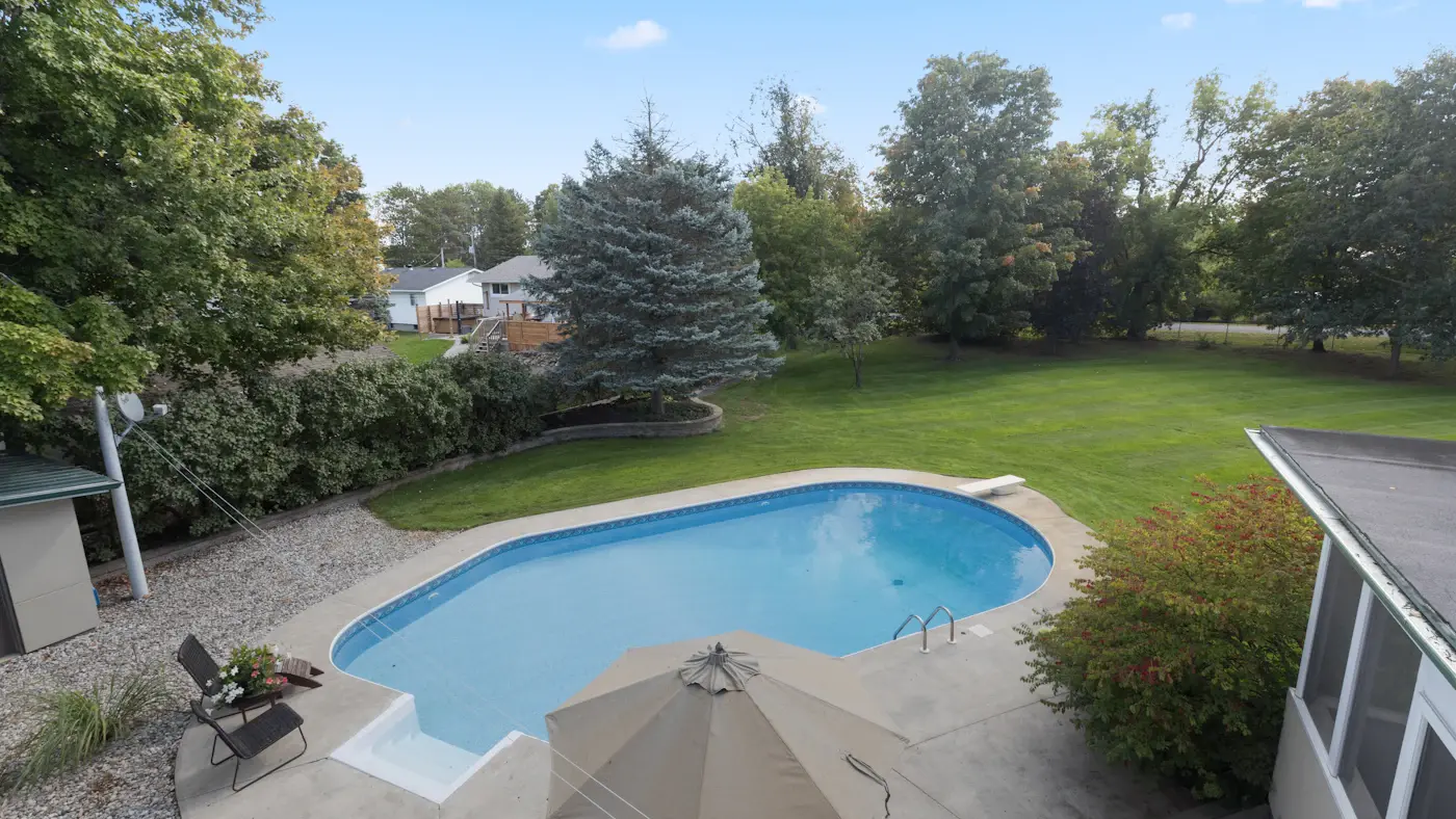 Aerial view of a villa backyard with a swimming pool and landscaped garden