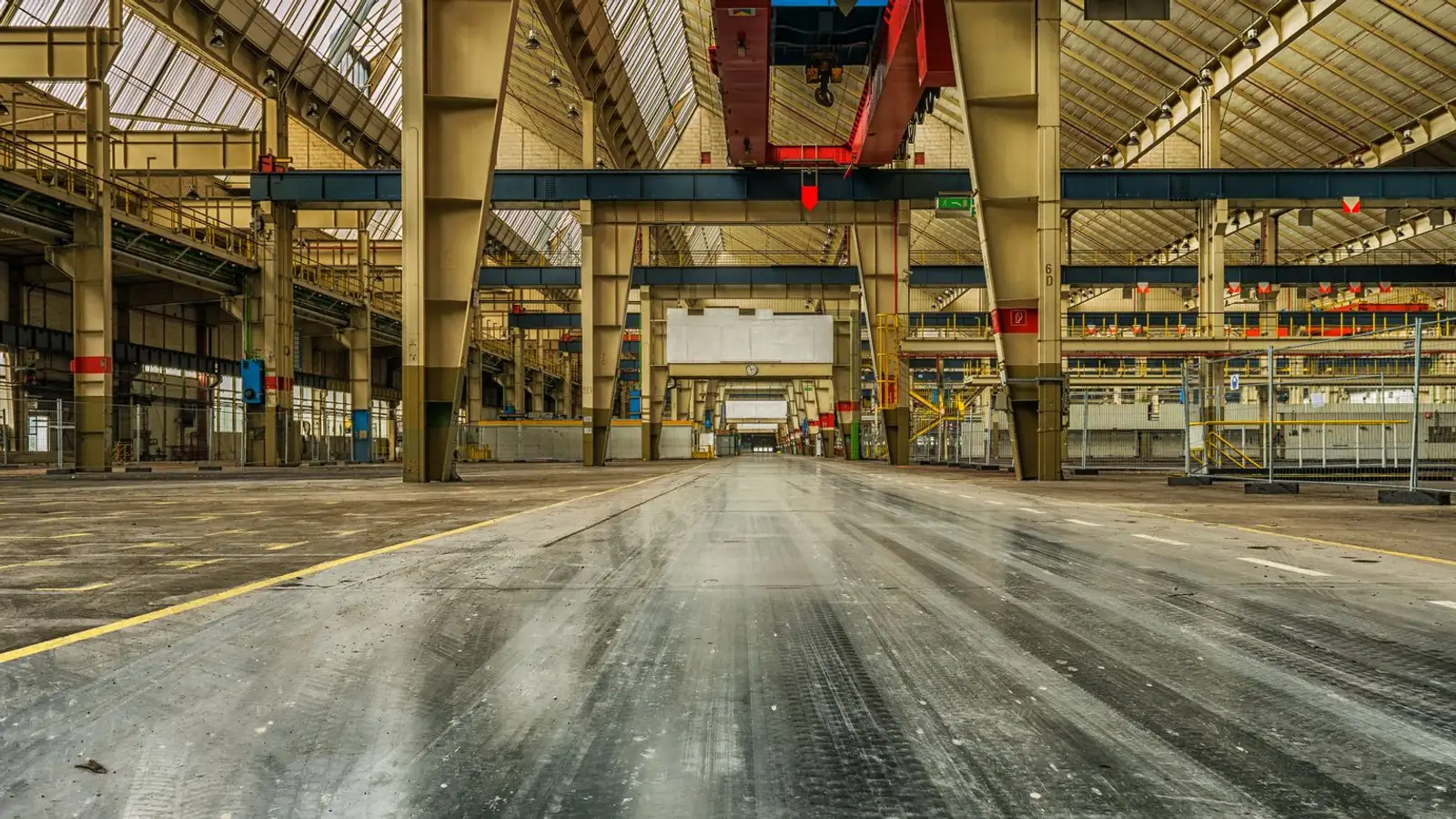 Large empty industrial warehouse interior cleared and swept during warehouse junk removal in Dubai