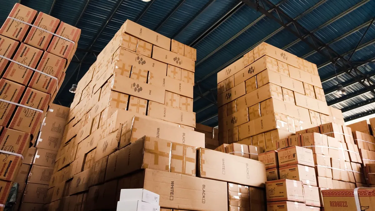 Stacked cardboard boxes and packaging waste in a Dubai warehouse ready for junk removal and recycling