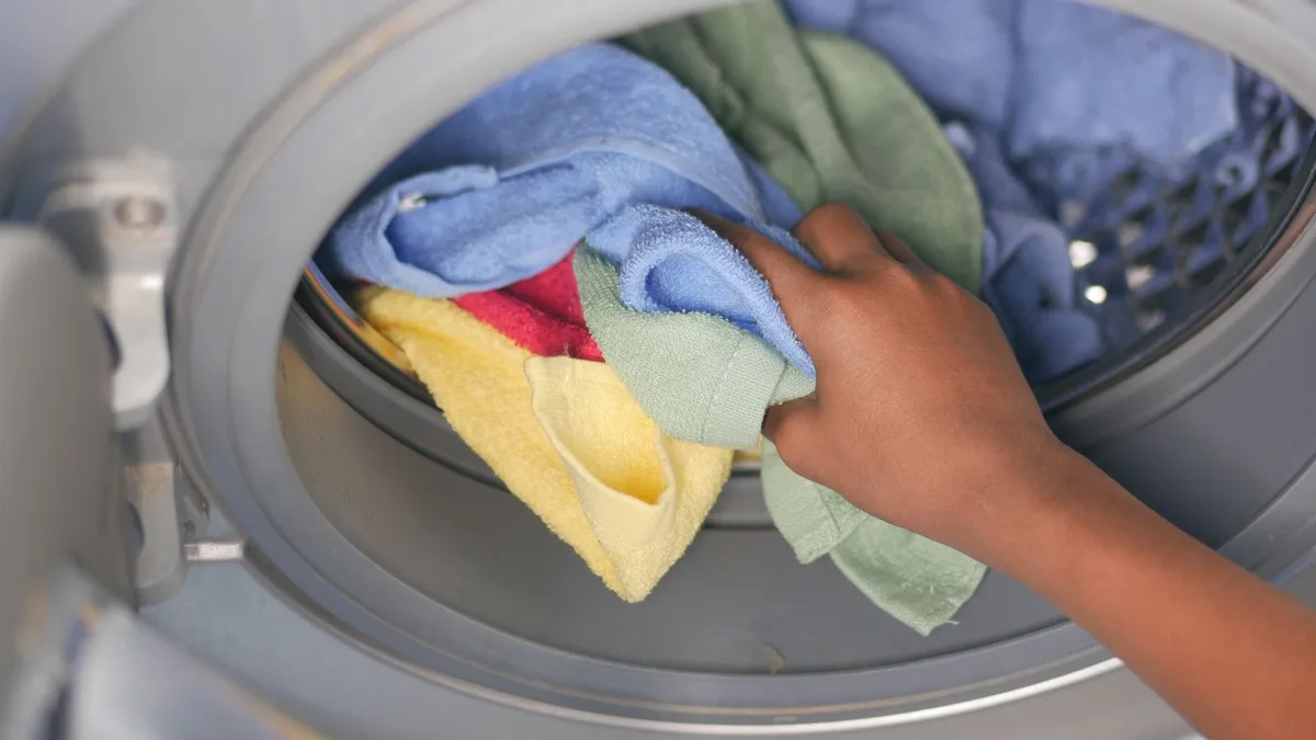 Front-load washing machine drum being emptied before washing machine pickup and appliance collection in Dubai