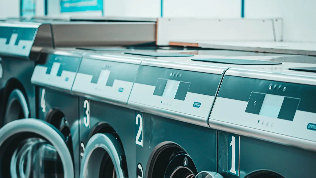 Row of washing machines representing laundry equipment disposal and washing machine recycling in Dubai