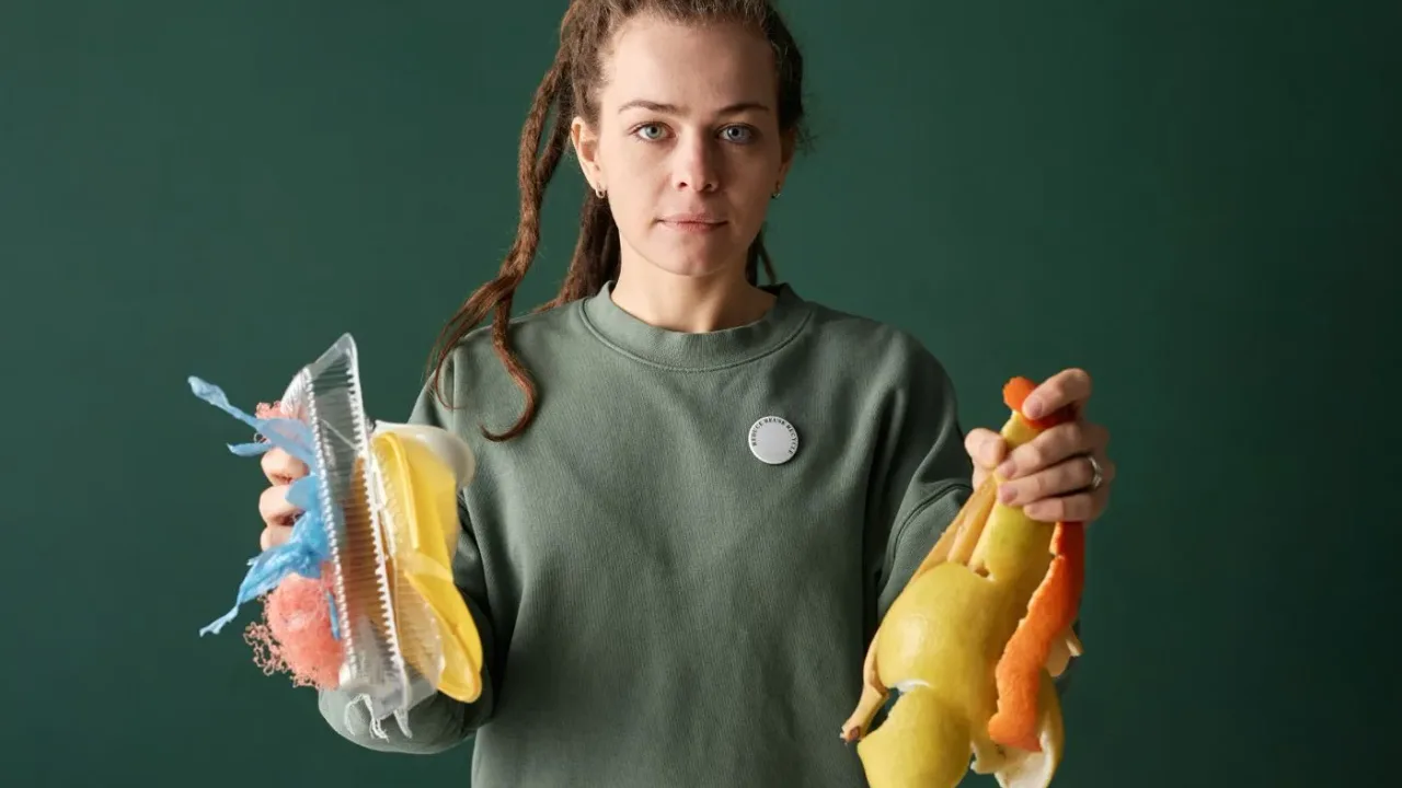 Woman comparing food peelings with plastic packaging to decide which waste stream each material belongs in